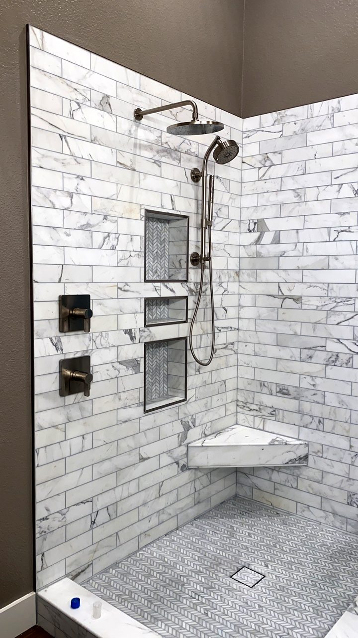 Floor-to-ceiling marble-look shower with built-in niches