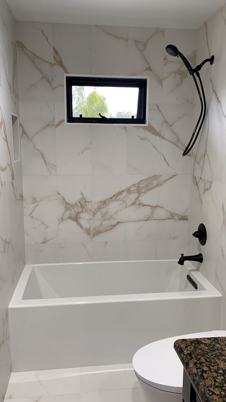 Gray tile walk-in shower with mosaic floor